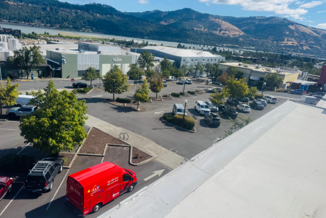 An A&E van in a commercial parking lot, working on a business' needs.