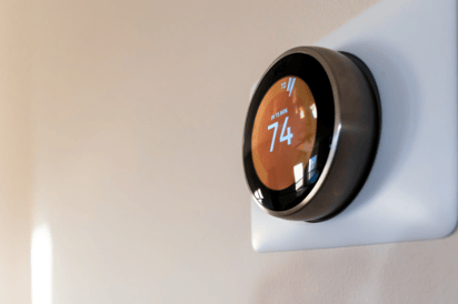 Wall-mounted Google Nest thermostat.