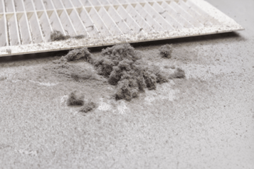 Dirty air filter with dust in front of it, showing how effective passive air filtration is at catching particles.