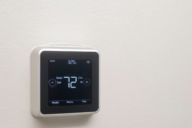 A wall-mounted Honeywell Smart Thermostat displaying that it is currently 72 degrees Fahrenheit. 