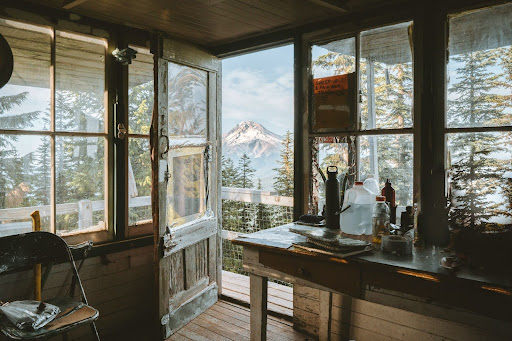 The inside of an Oregon home with a view of Mt. Hood through the open front door.