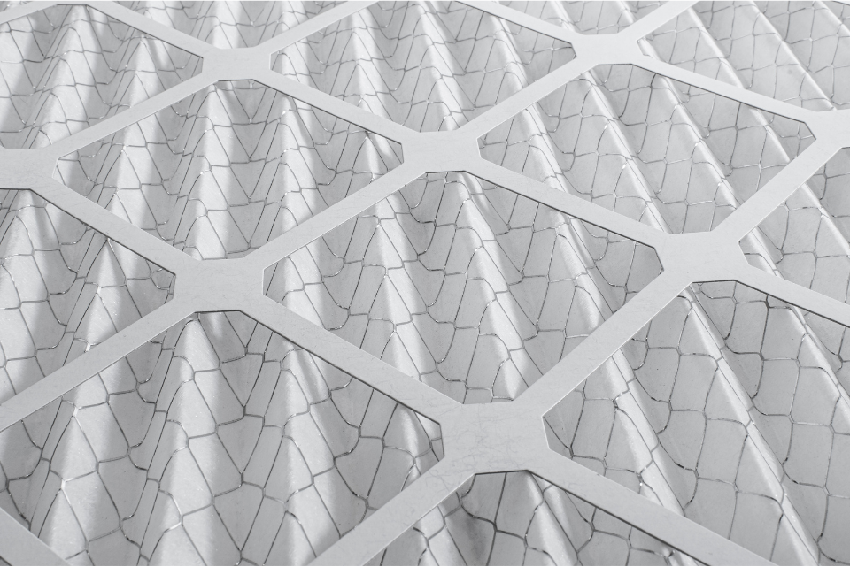 A closeup shot of a clean, pleated HVAC air filter.