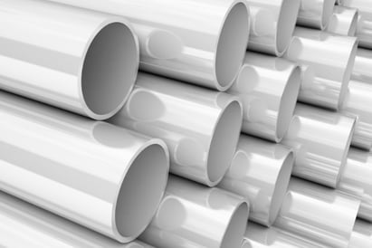 A shot of several PVC pipes stacked tall.