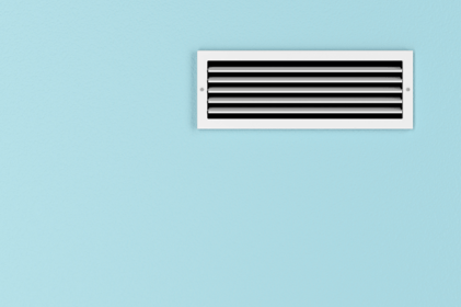 A white HVAC vent on an egg-shell blue wall.