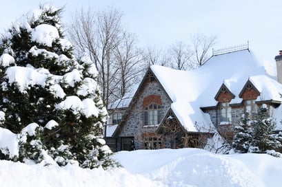 A home sits covered in snow after a snow storm.